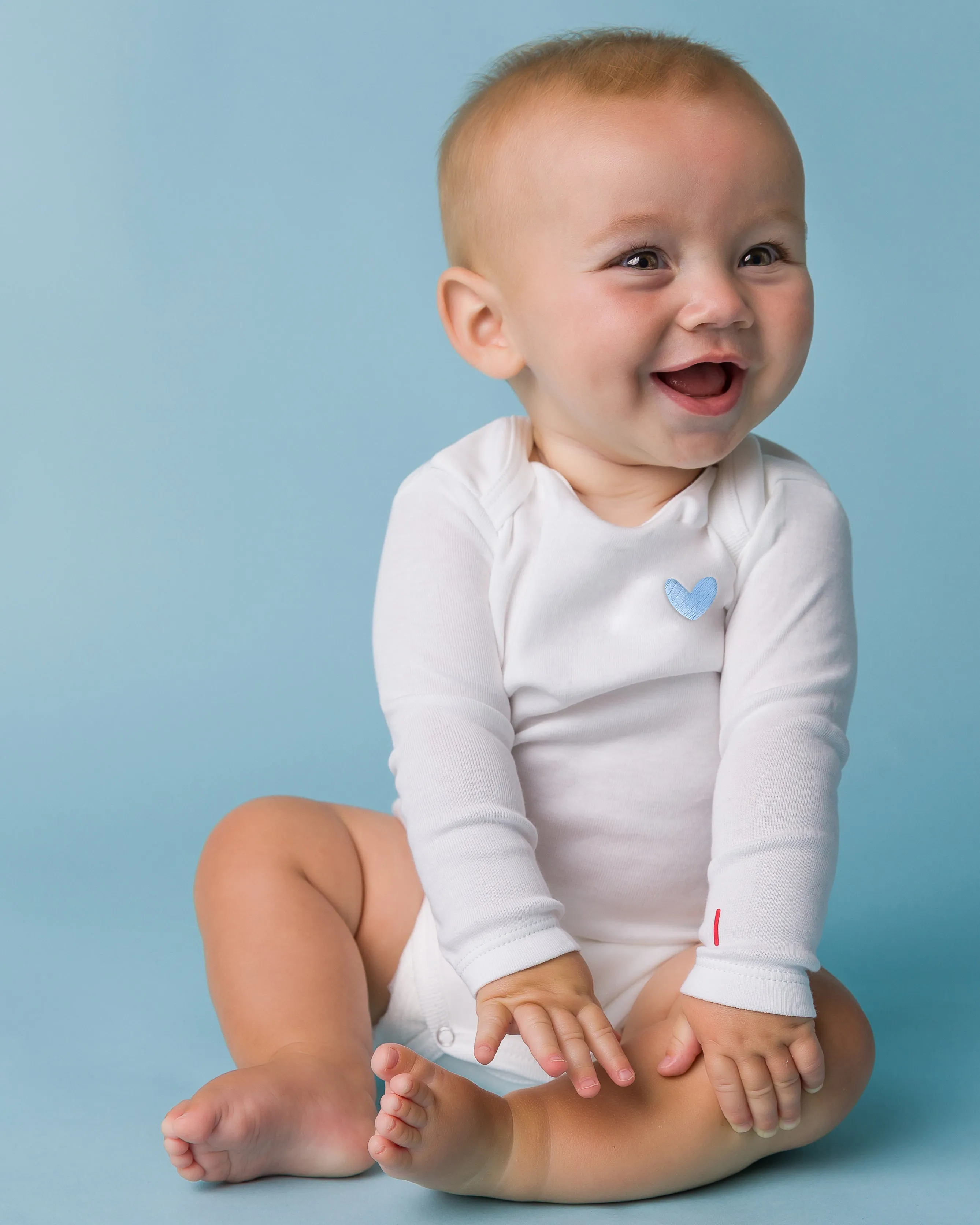 The Organic Embroidered Long Sleeve Onesie [White with Blue Heart]